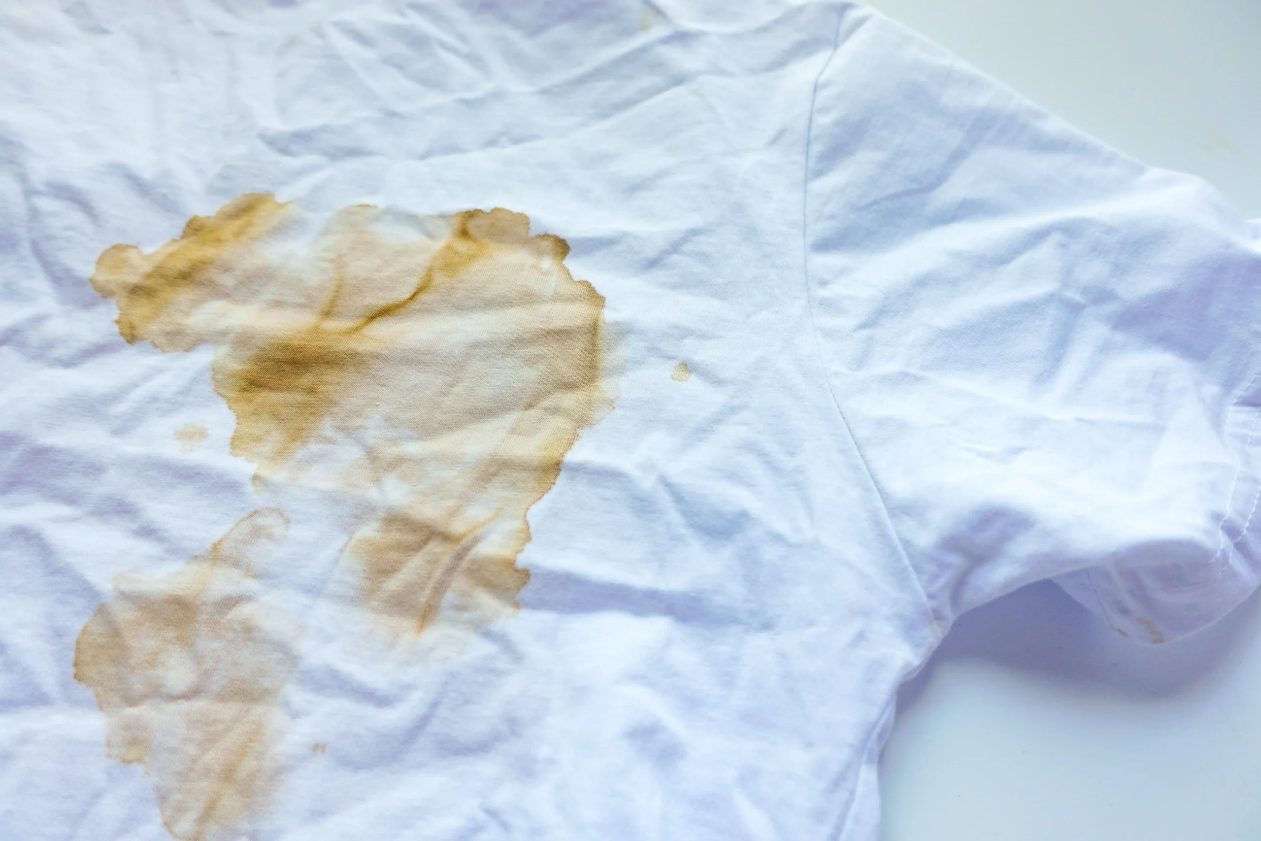 How to Get Rid of Sweat Stains From White Shirts – white cotton shirt with visible yellow-brown sweat stains on the fabric